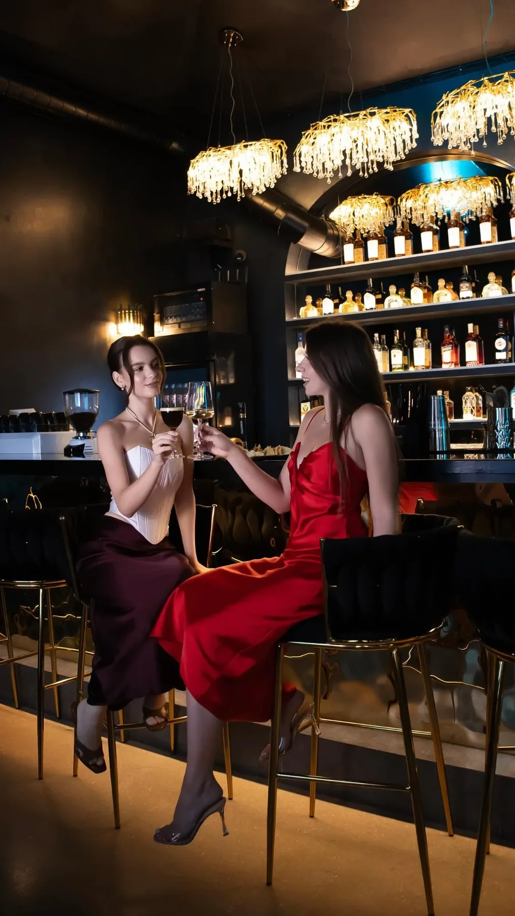 Two guests toasting at the bar