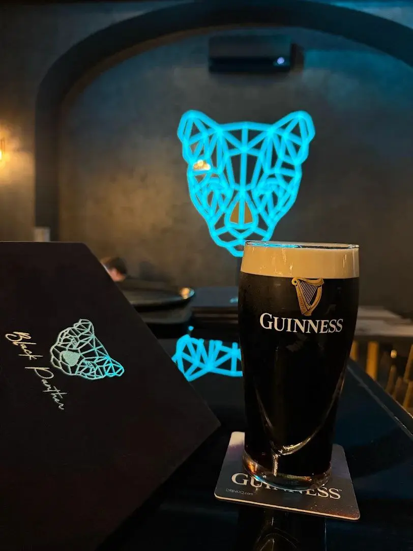 A Guinness beside the menu, under the sign
