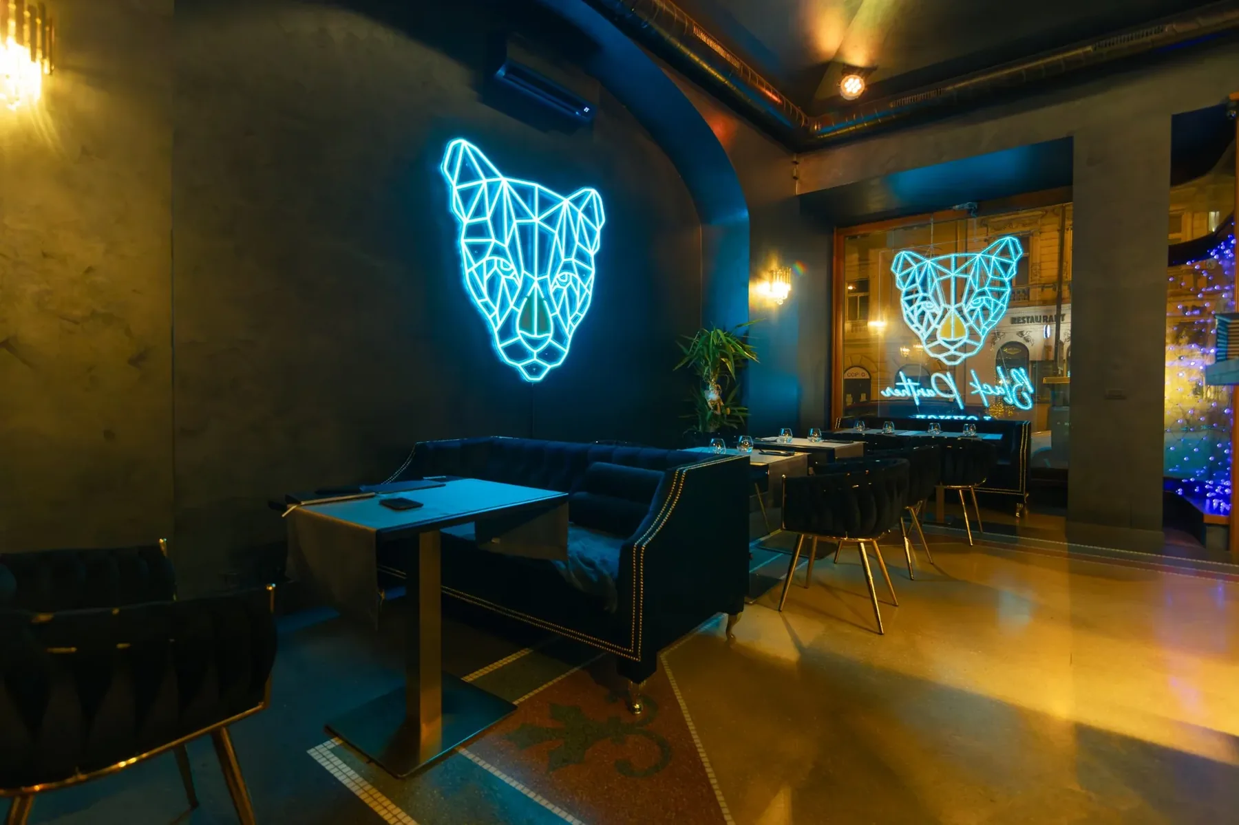 The lounge, with the neon panther over the banquette