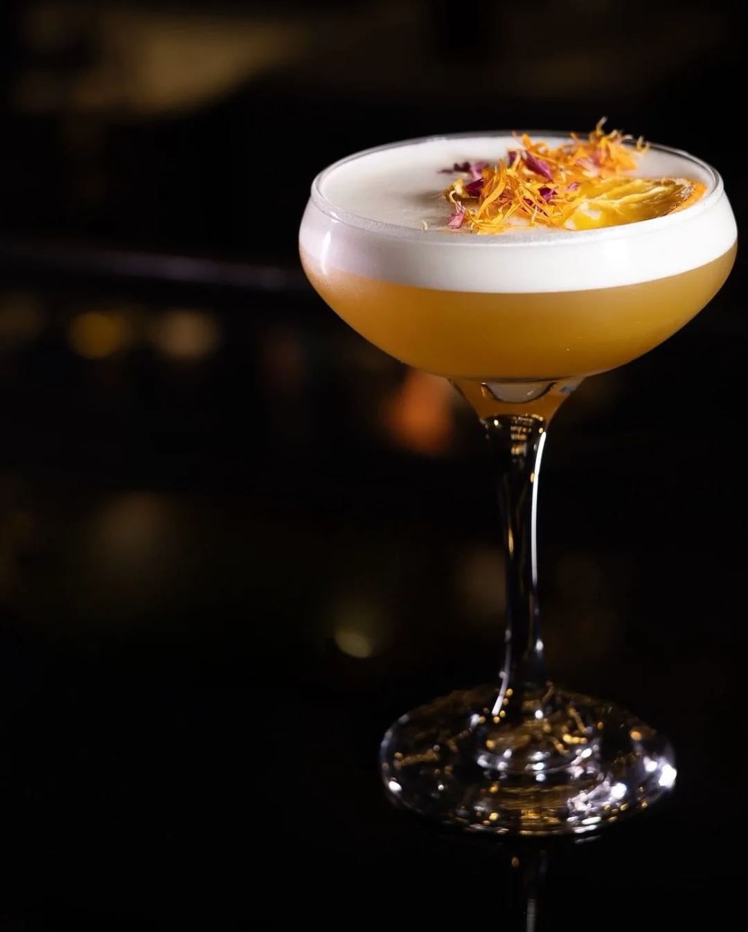 A coupe finished with dried flowers on the black bar top